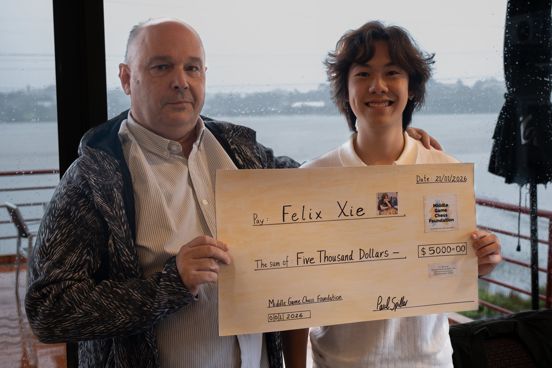Felix Xie receiving his $5,000 scholarship cheque from MGCF Treasurer Martin Dreyer